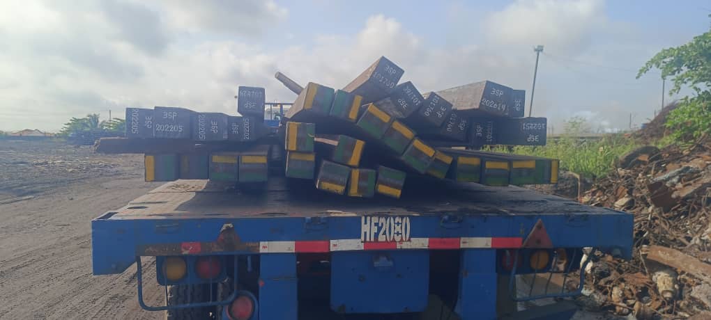 Fleet of trucks moving steel